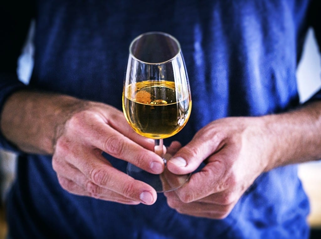 Mann hält Whiskyglas