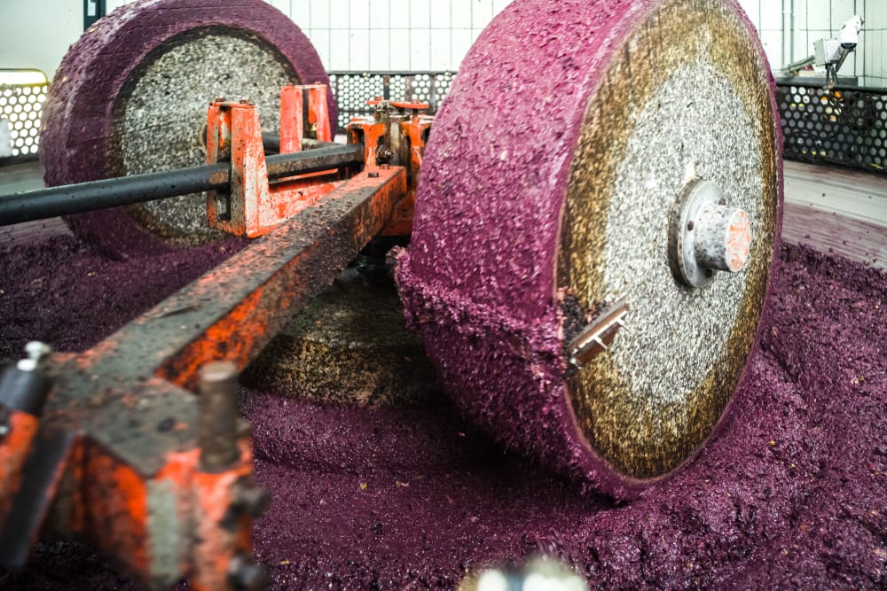 Zerquetschen der Oliven mit Granitsteinen